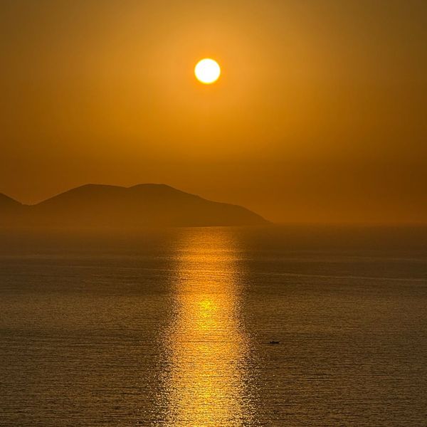 A serene landscape with calm water reflecting the sky.